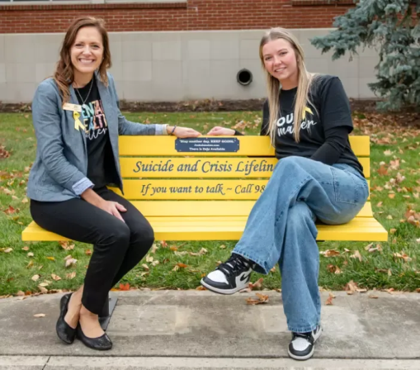 Janel Molnar and Sarah Watson on the suicide awareness bench. 