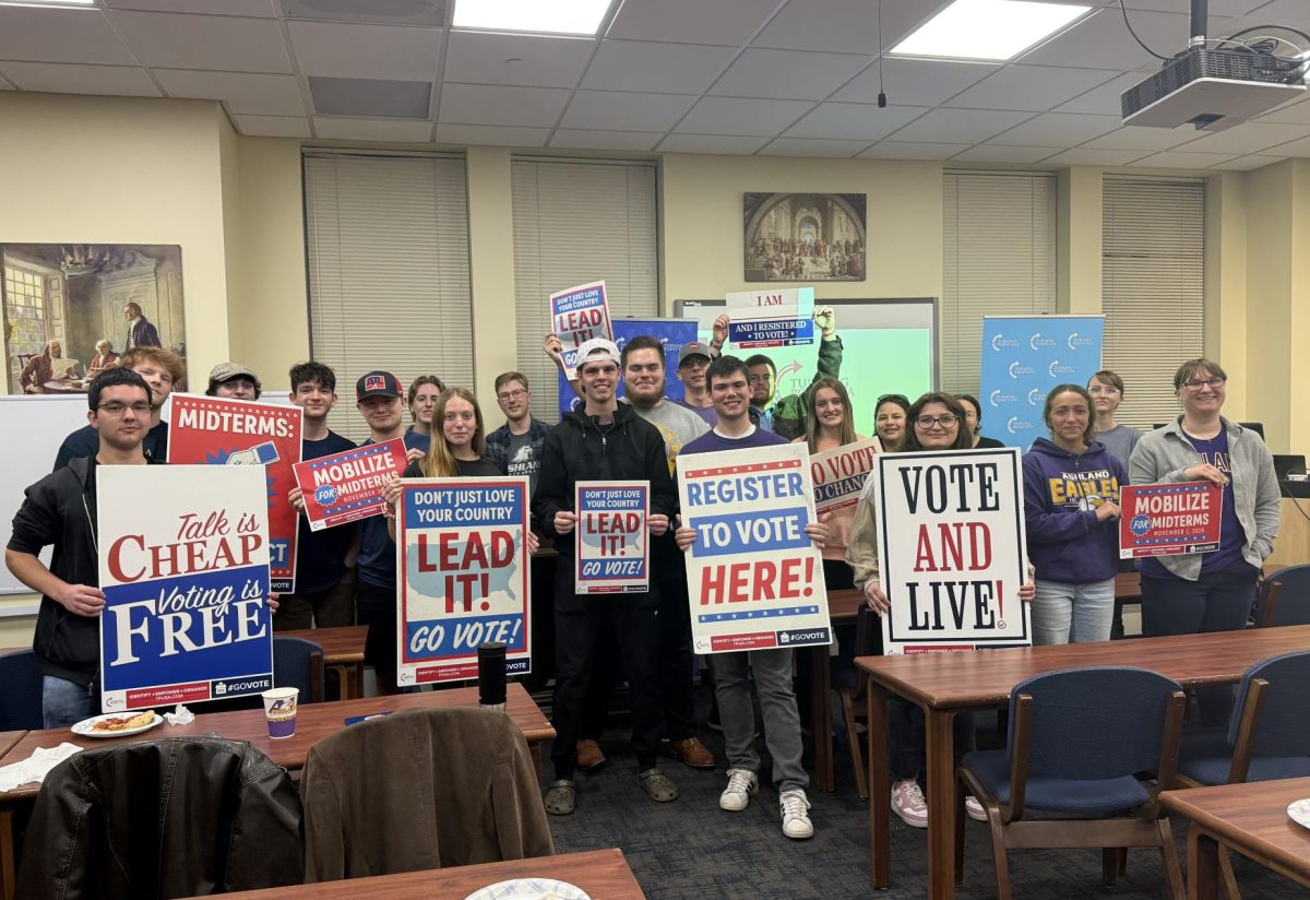 Members of the chapter who attended the meeting holding signs that were provided.  